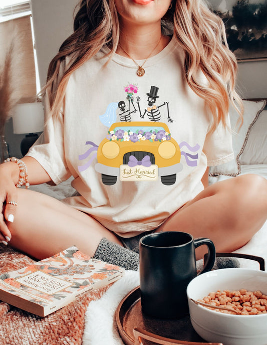 A woman wearing a cute ivory colored shirt with a newlywed couple holding flowers and waving goodbye from a gold colored car with the text Just Married on the front of the vehicle.