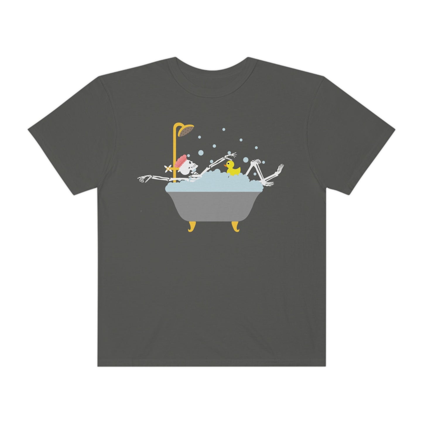 A woman wearing a cute green colored shirt with a female skeleton wearing a pink bath cap is taking a bubble bath with a yellow rubber ducky, the bath is gold and gray colored and the air is filled with bubbles.