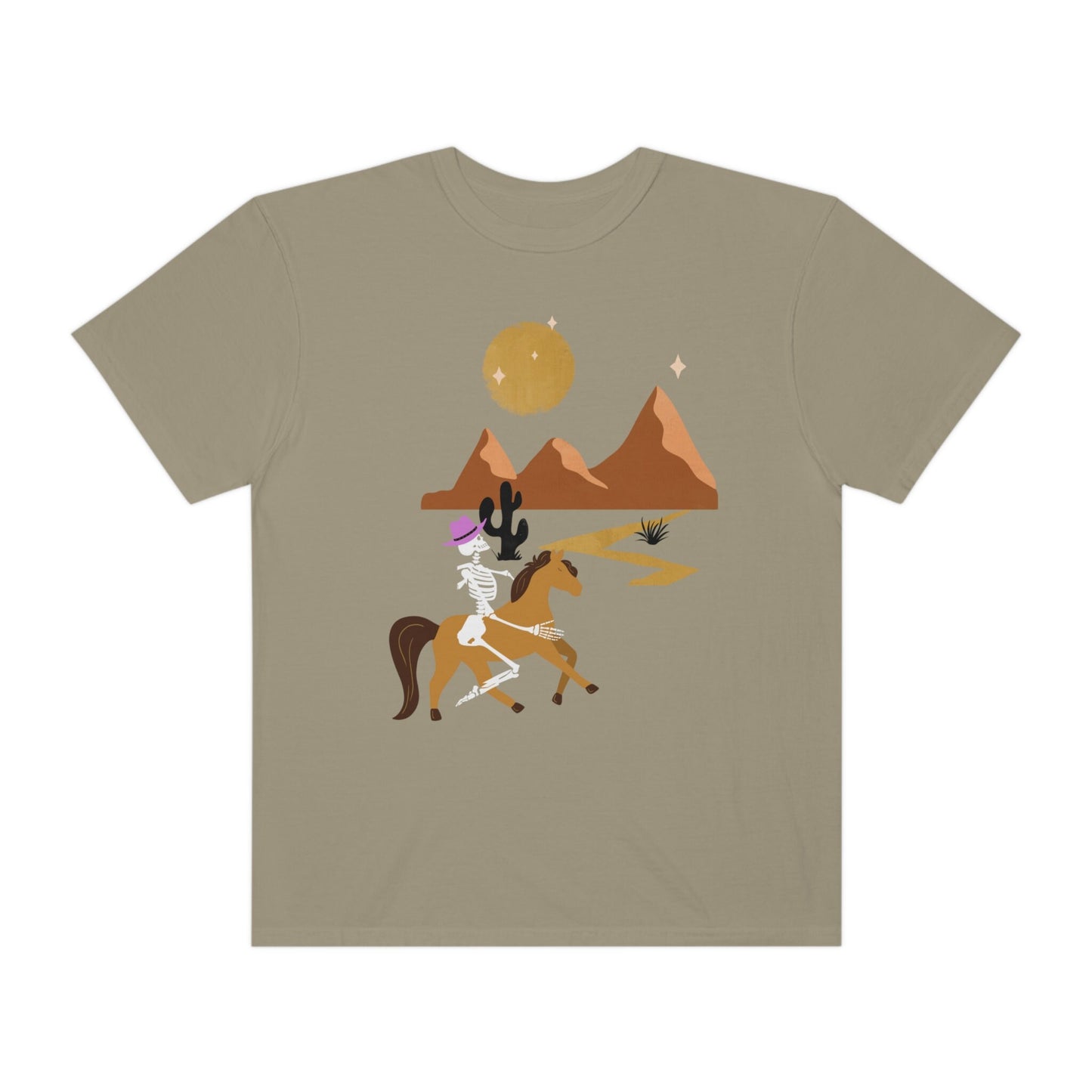 A vintage, khaki colored shirt with a skeleton cowgirl wearing a pink cowboy hat riding a brown horse through the eset at night, cacti and three mountains in the background with a full moon and stars in the sky.