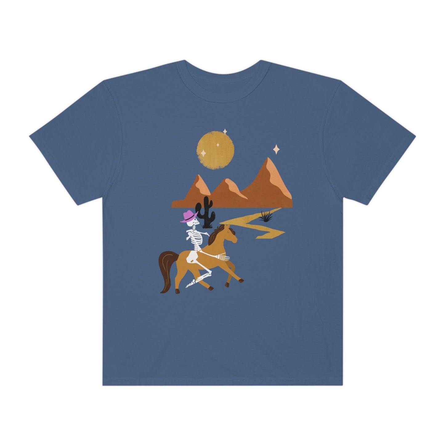 A vintage, midnight colored shirt with a skeleton cowgirl wearing a pink cowboy hat riding a brown horse through the eset at night, cacti and three mountains in the background with a full moon and stars in the sky.