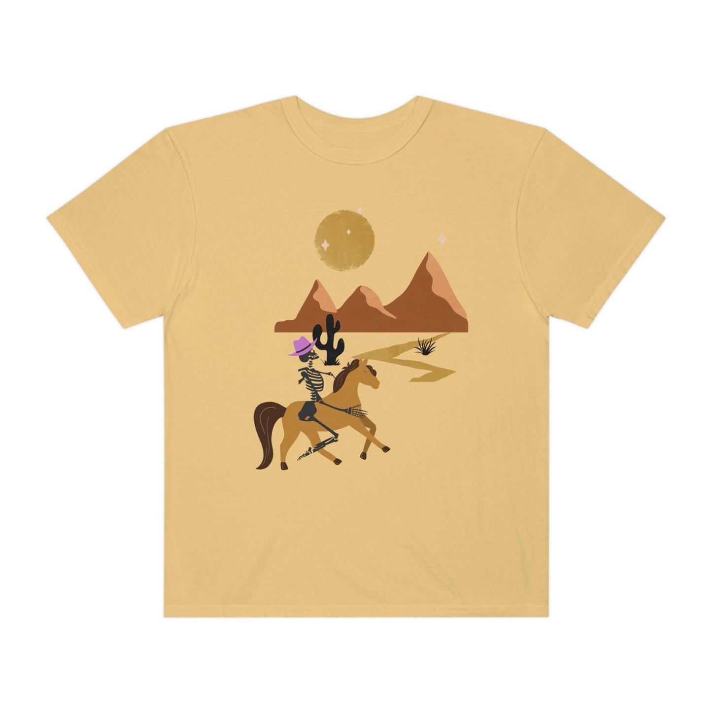 A vintage, mustard colored shirt with a skeleton cowgirl wearing a pink cowboy hat riding a brown horse through the eset at night, cacti and three mountains in the background with a full moon and stars in the sky.