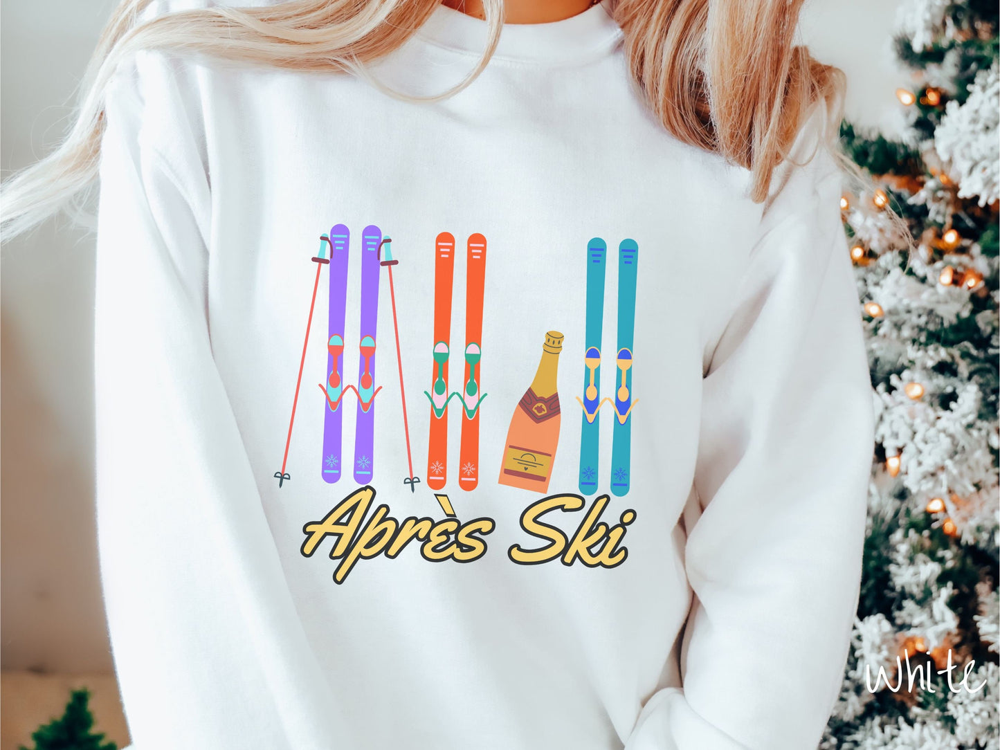 A woman wearing a vintage, white colored sweatshirt with sets of purple, orange, and turquoise snow skis standing upright, and a big bottle of champagne next to them. Below the skis is the text Apres Ski which is French for After Skiing.