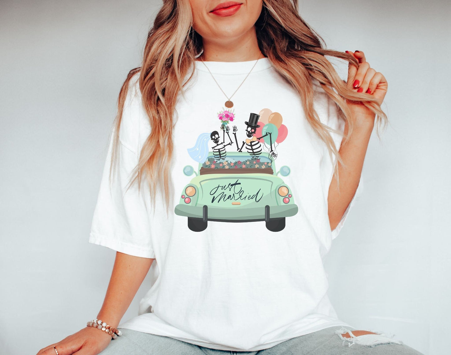 A woman wearing a cute white colored shirt with a newlywed couple holding flowers and balloons waving goodbye from a light green car with the text Just Married on the rear of the vehicle.