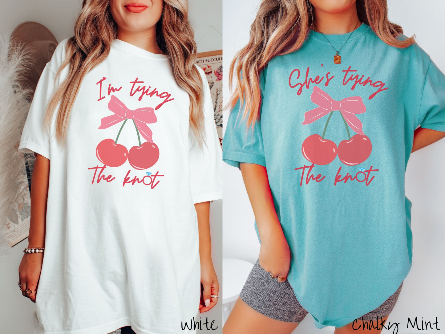 Two women wearing cute, vintage white and chalky mint colored Comfort Colors t-shirts with text Im tying the knot in red, cursive font. The o in knot is a diamond wedding ring. Between the text are two cherries tied together with a red bow.