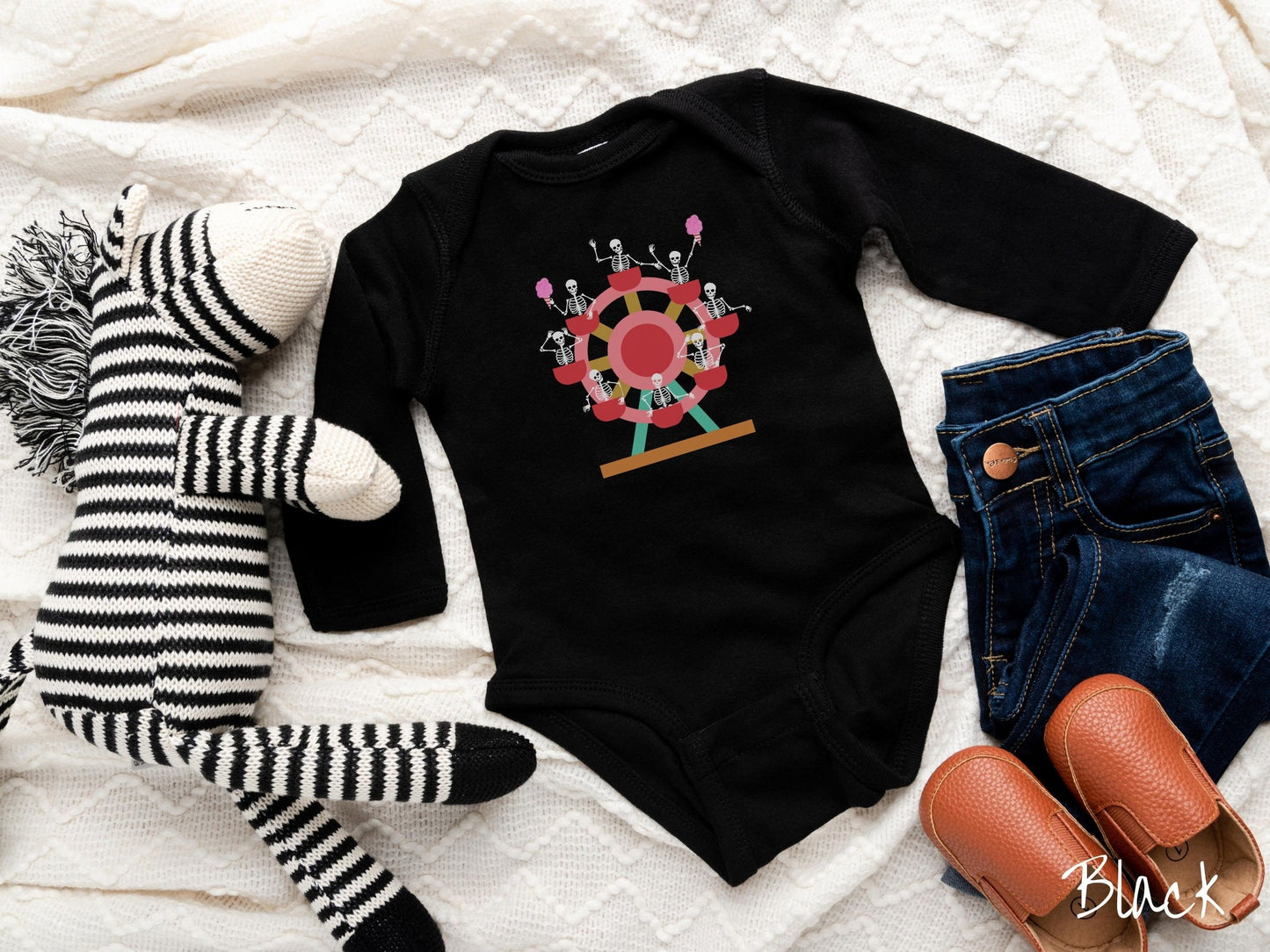 A cute black colored body suit with a ferris wheel filled with black skeletons waving and holding cotton candy as they go around the ride.