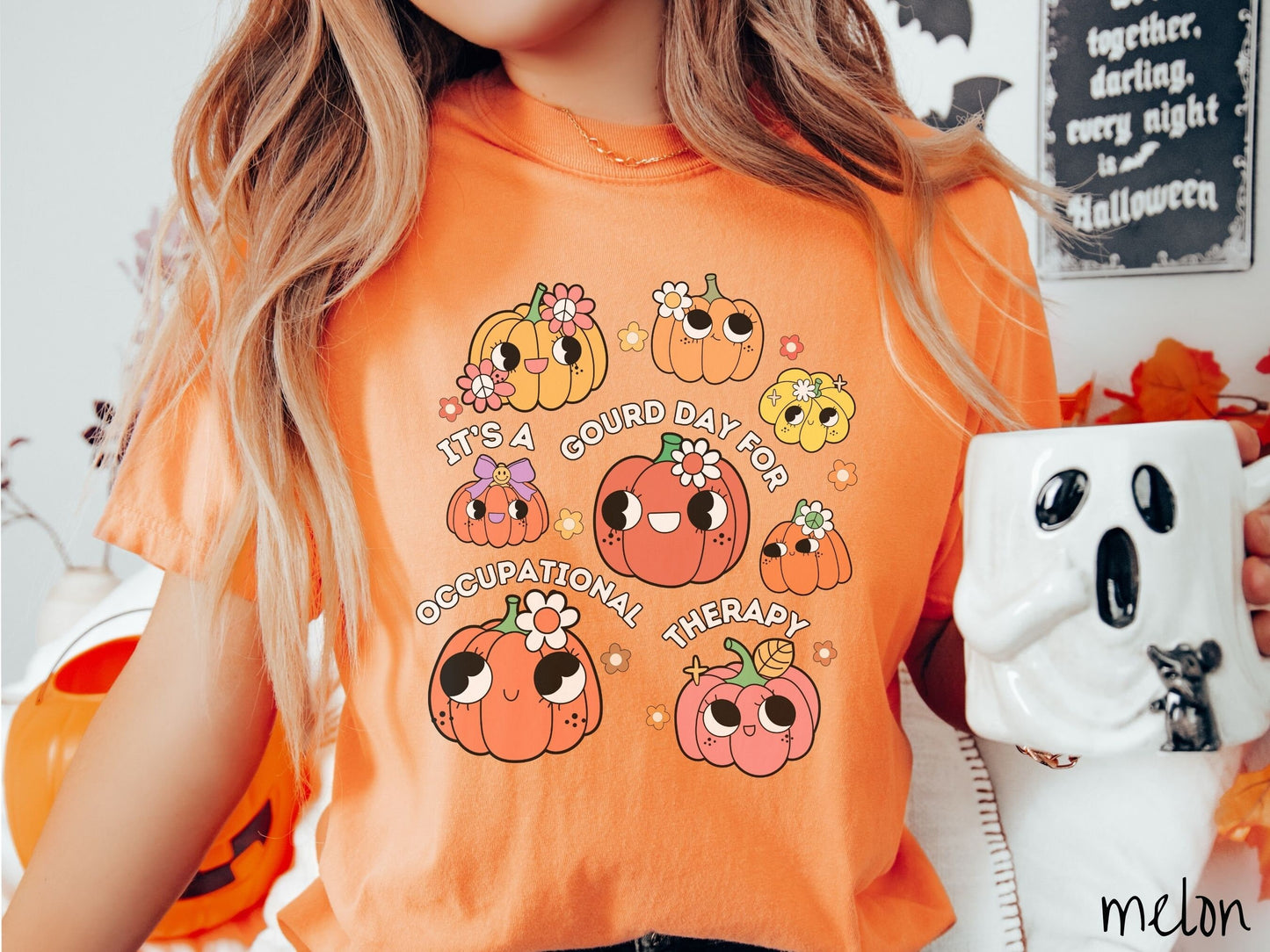 A woman wearing a cute, vintage melon colored Comfort Colors T-shirt with text Its a Gourd Day for Occupational Therapy in white font. There is a three by three grid of orange, yellow, and pink pumpkins with girly eyes, wearing flowers and bows.