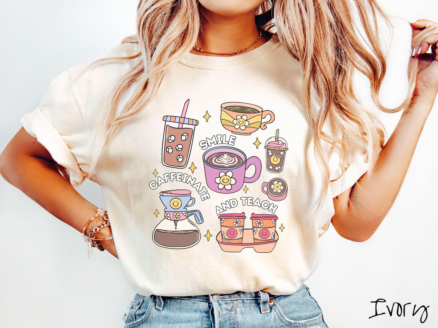 A woman wearing a cute, vintage ivory colored Comfort Colors T-shirt with text Smile Caffeinate and Teach. There is an iced coffee, two cups of hot coffee, a blended coffee drink with whipped cream, to-go coffees, and a pot of coffee.