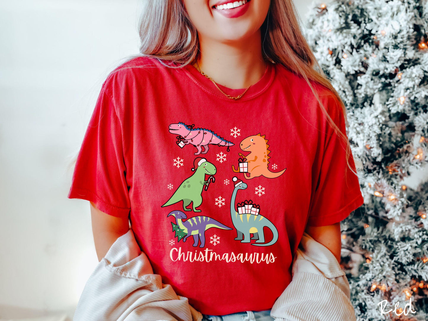 Get into the festive spirit with this adorable red colored Christmasaurus Comfort Colors T-shirt. Featuring a variety of colorful dinosaurs dressed up for the holidays, this tee exudes a playful and cheerful vibe.