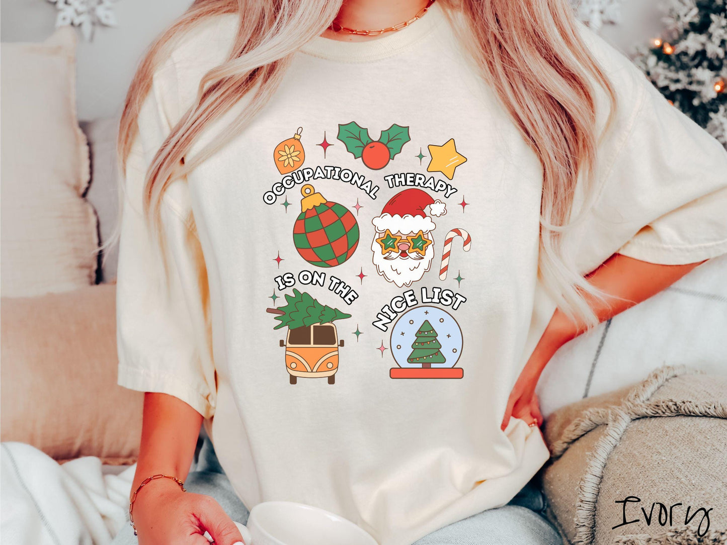 This vintage ivory colored Comfort Colors T-shirt features the text 'Occupational Therapy is on the nice list' in white font, surrounded by Christmas lights, cranberries, Santa Claus, a candy cane, a snow globe, and other festive decorations.