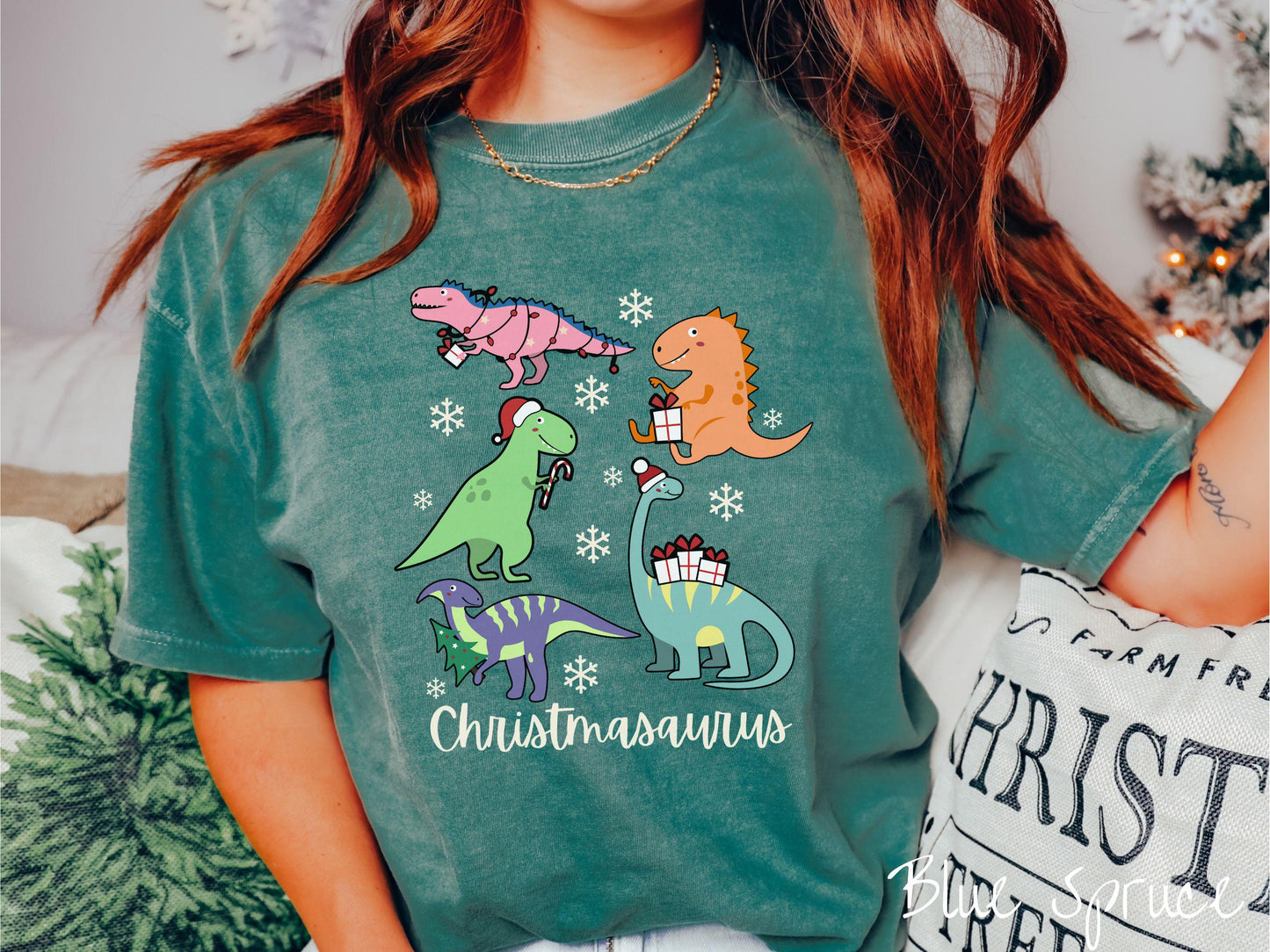 Get into the festive spirit with this adorable blue spruce colored Christmasaurus Comfort Colors T-shirt. Featuring a variety of colorful dinosaurs dressed up for the holidays, this tee exudes a playful and cheerful vibe.