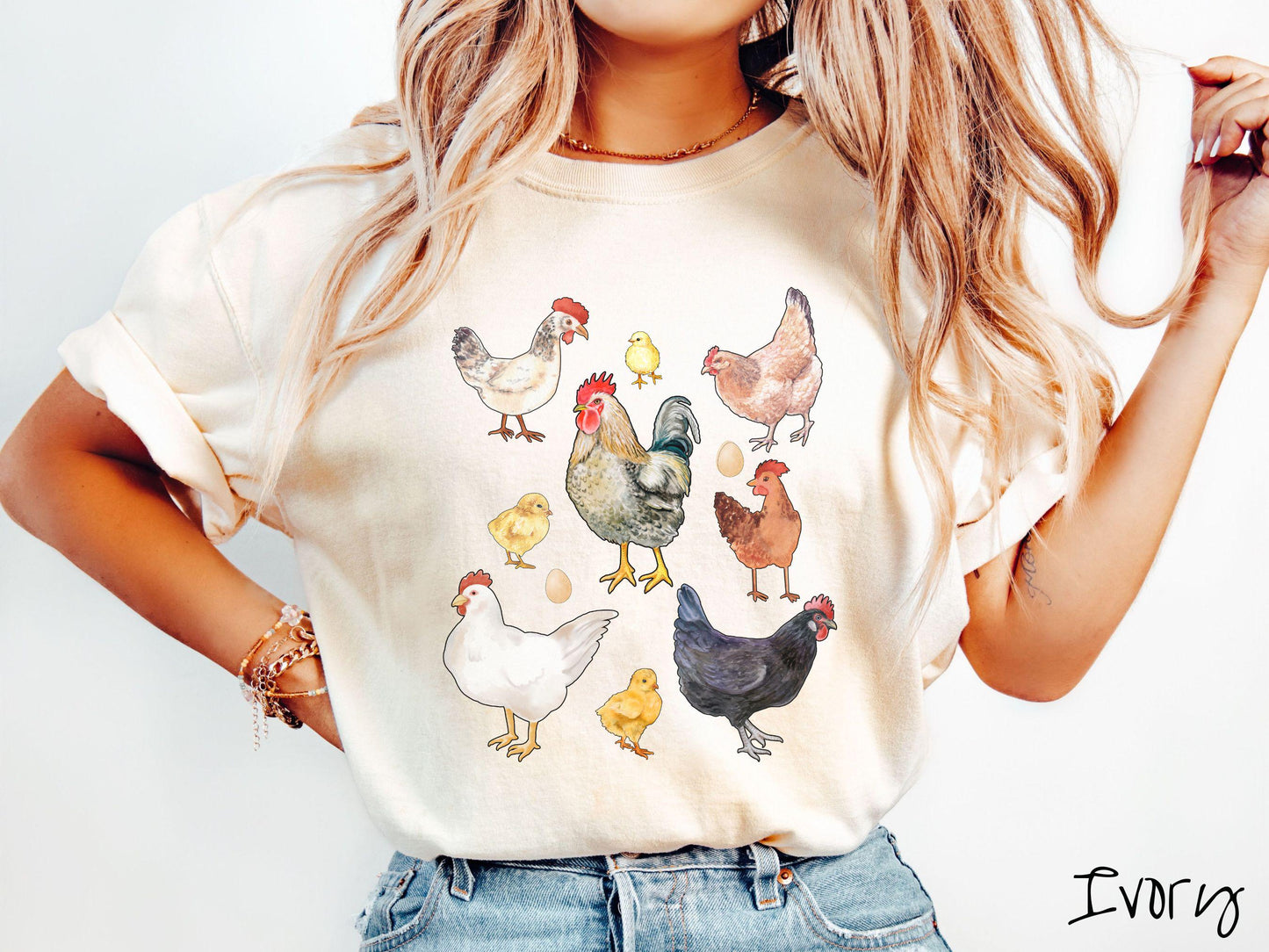 A vintage ivory colored Comfort Colors t-shirt featuring a grid style design of assorted colorful chickens, hens, and roosters in a grid design, with chicken eggs scattered among the design.