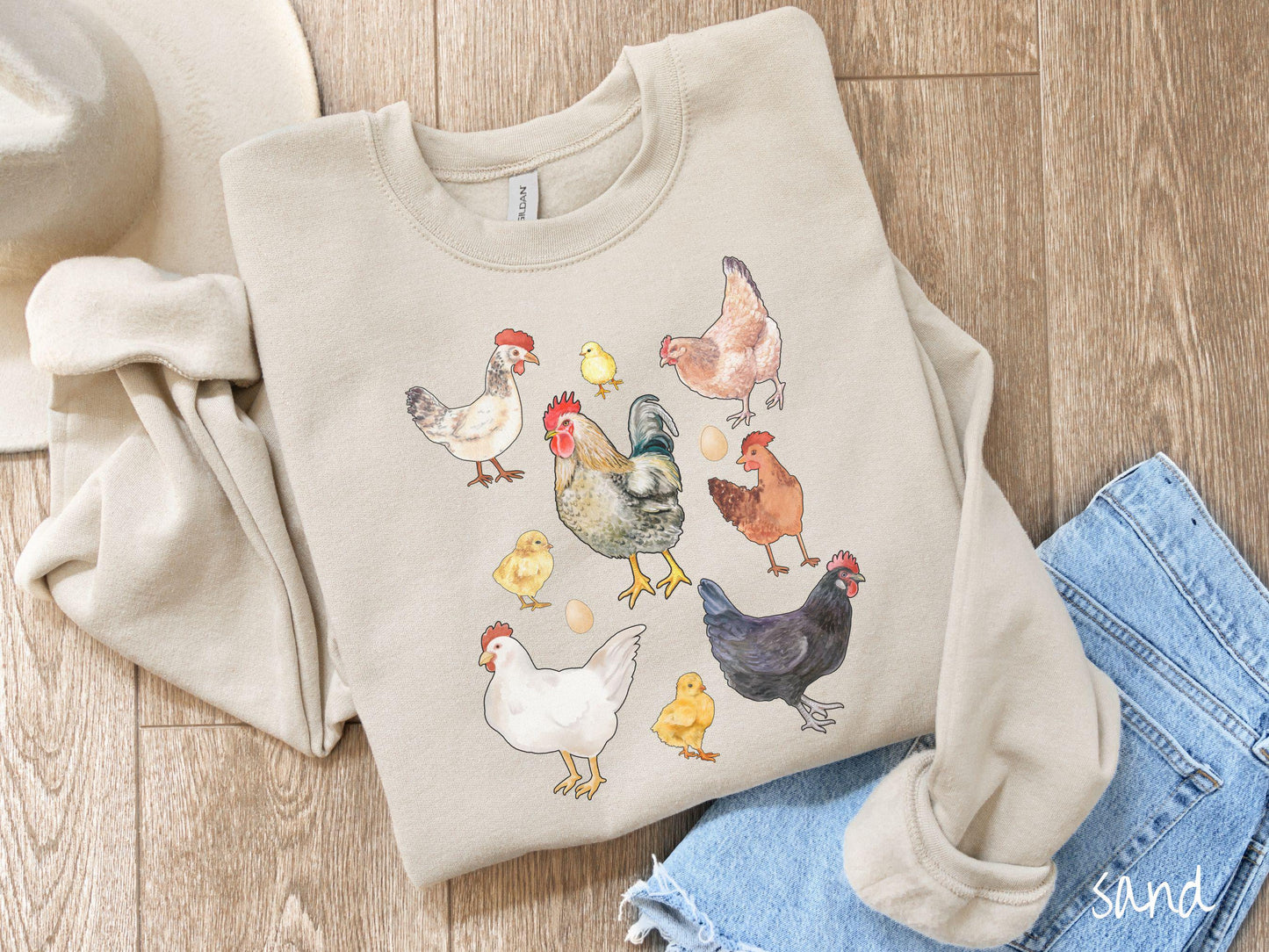 A vintage sand colored Gildan sweatshirt featuring a grid style design of assorted colorful chickens, hens, and roosters in a grid design, with chicken eggs scattered among the design.
