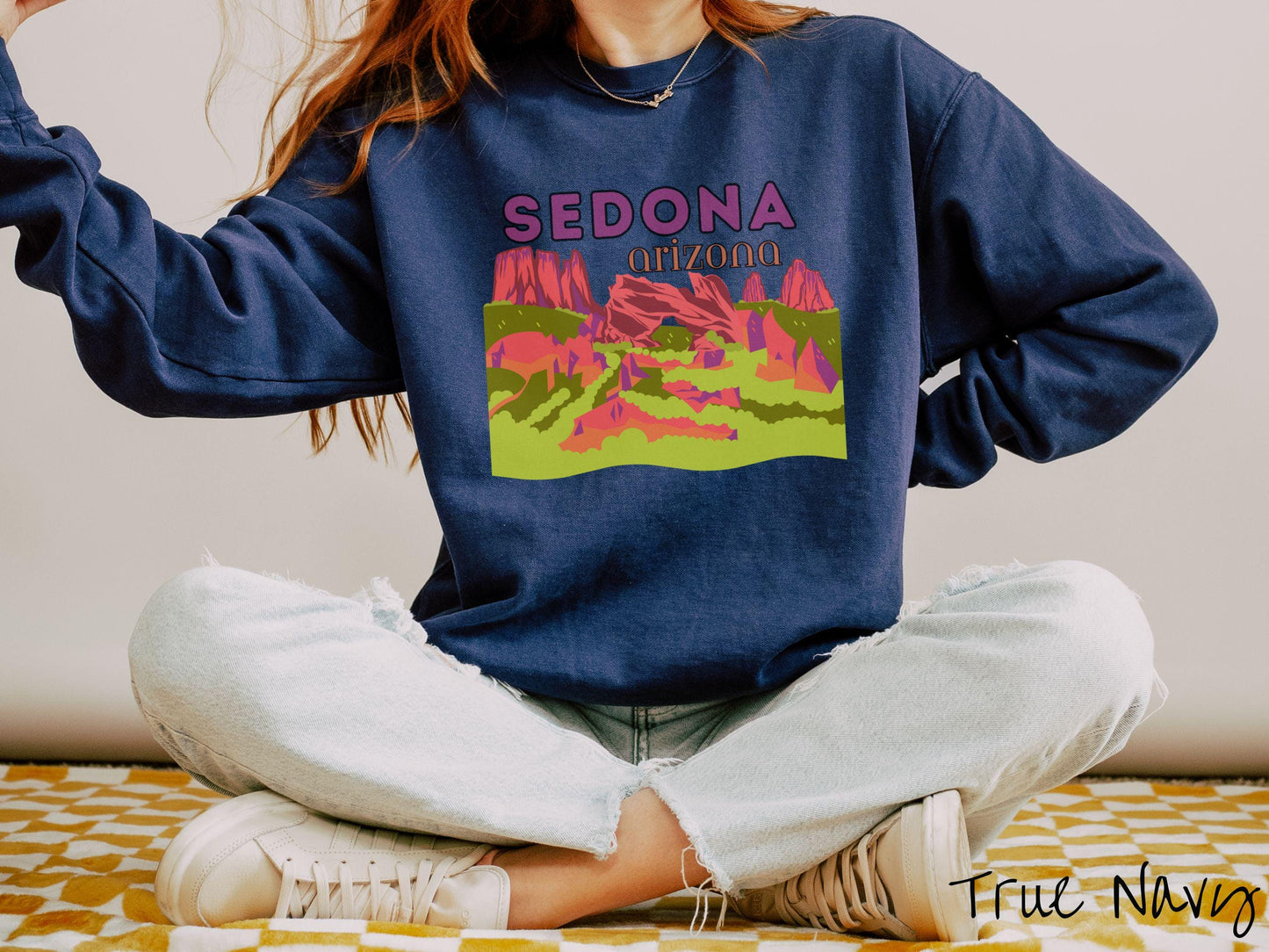 A colorful, vintage true navy colored Gildan sweatshirt with a scenic viewof Sedona, Arizona. There is an aerial view of the Devil's Bridge rock formation with greenery and rocks in the background.