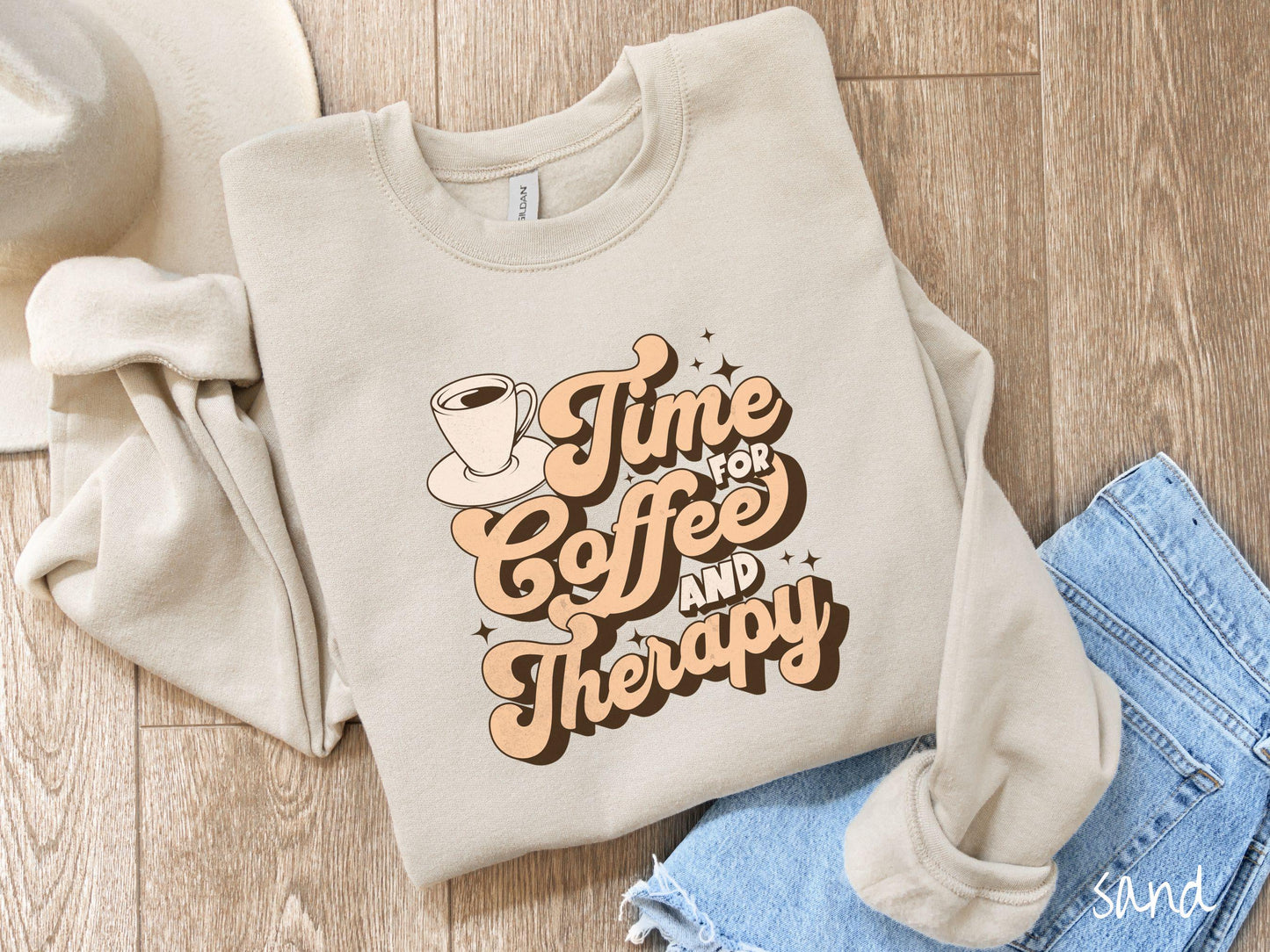 A vintage, sand colored Gildan sweatshirt featuring the text Time for Coffee and Therapy with a cup of coffee and stars in the background, giving off a cozy and comforting vibe.
