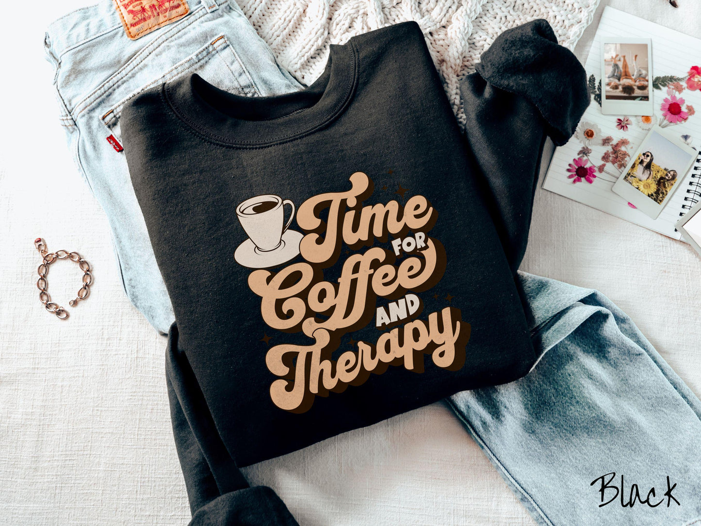 A vintage, black colored Gildan sweatshirt featuring the text Time for Coffee and Therapy with a cup of coffee and stars in the background, giving off a cozy and comforting vibe.