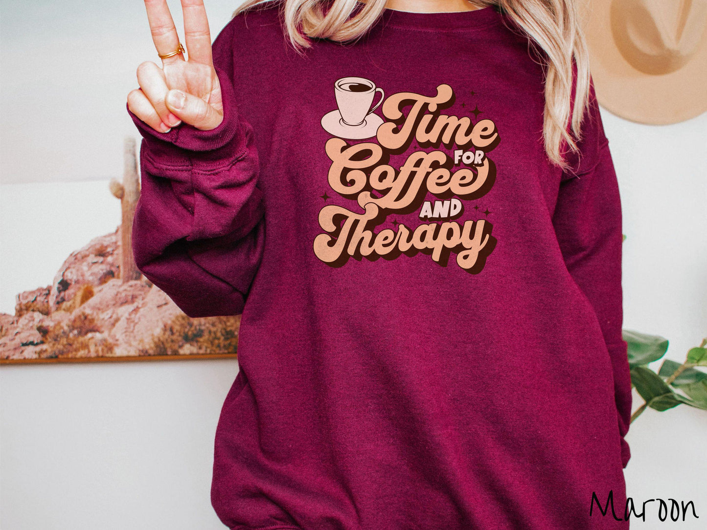 A vintage, maroon colored Gildan sweatshirt featuring the text Time for Coffee and Therapy with a cup of coffee and stars in the background, giving off a cozy and comforting vibe.