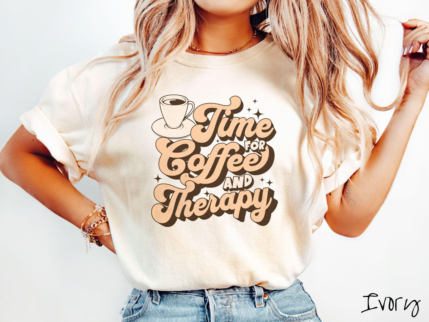 A vintage, ivory colored Comfort Colors t-shirt featuring the text Time for Coffee and Therapy with a cup of coffee and stars in the background, giving off a cozy and comforting vibe.