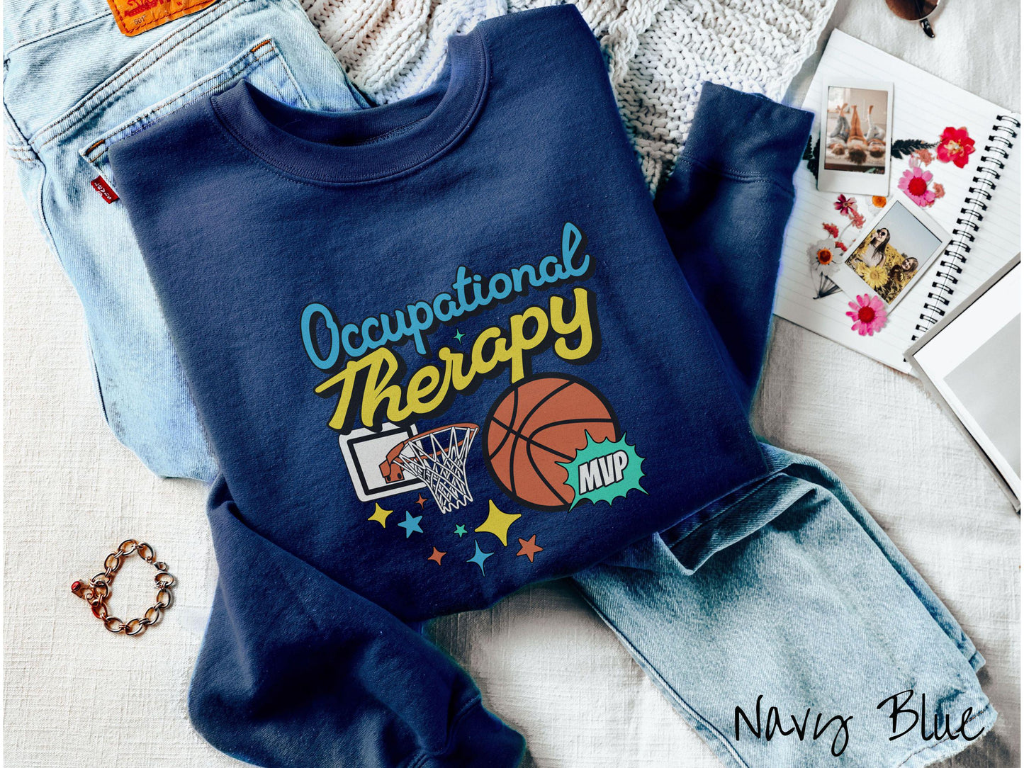 A vintage, navy blue colored Gildan sweatshirt features the phrase "Occupational Therapy" above a basketball goal, complemented by a bold basketball graphic with the text "MVP".