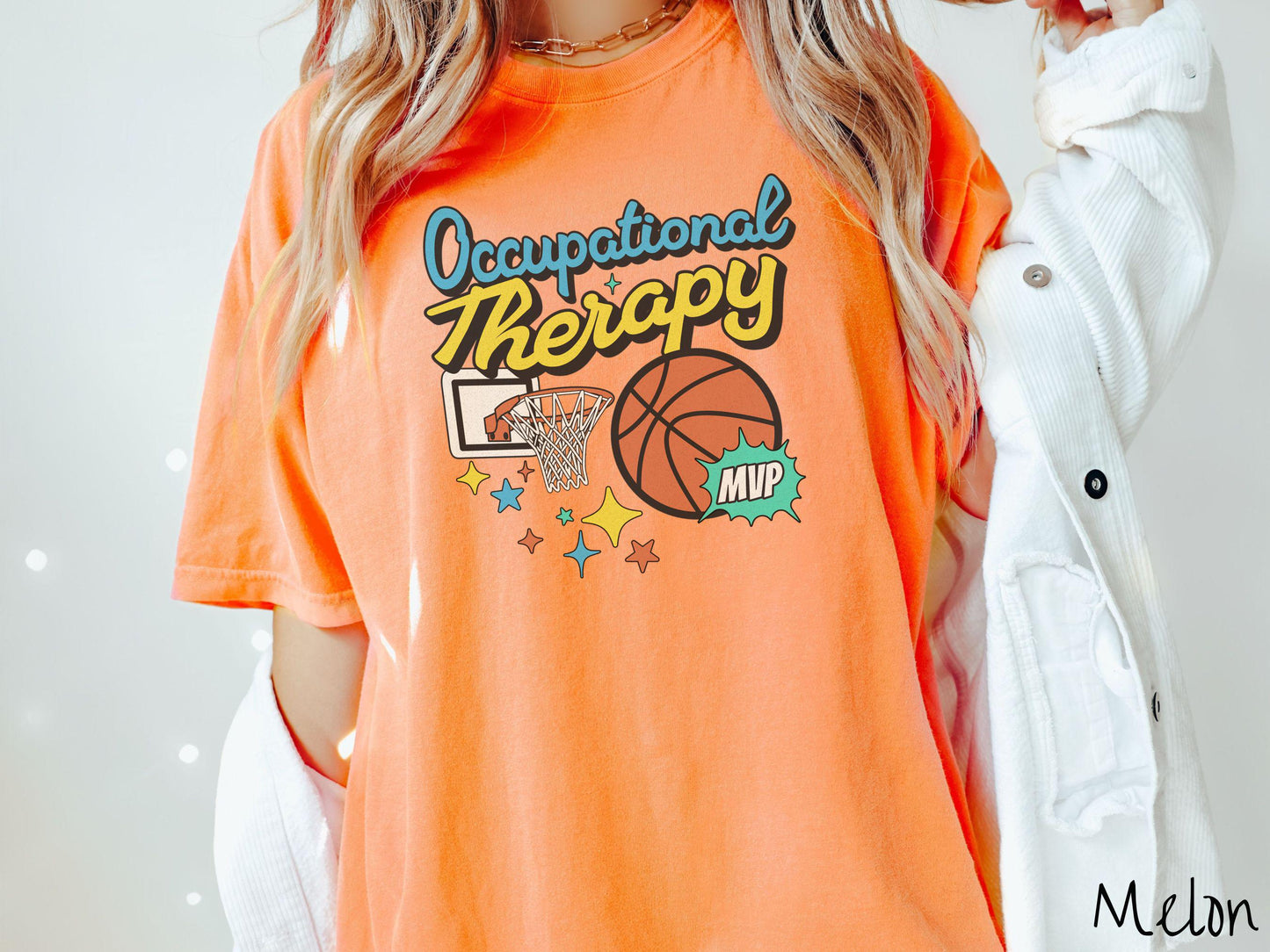 A vintage, melon colored Comfort Colors T-Shirt features the phrase "Occupational Therapy" above a basketball goal, complemented by a bold basketball graphic with the text "MVP".