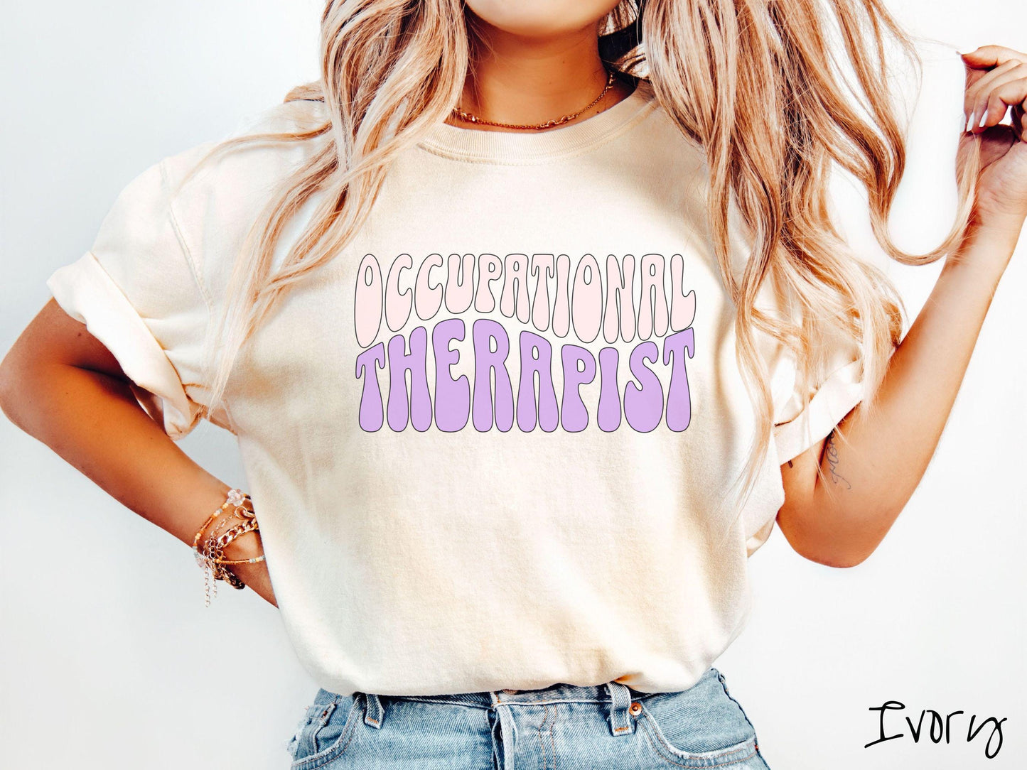 A vintage, ivory colored Comfort Colors t-shirt featuring the text Occupational Therapist in fun wavy font. This sweater is perfect for occupational therapists looking to add a touch of personality to their casual or semi-formal outfits.