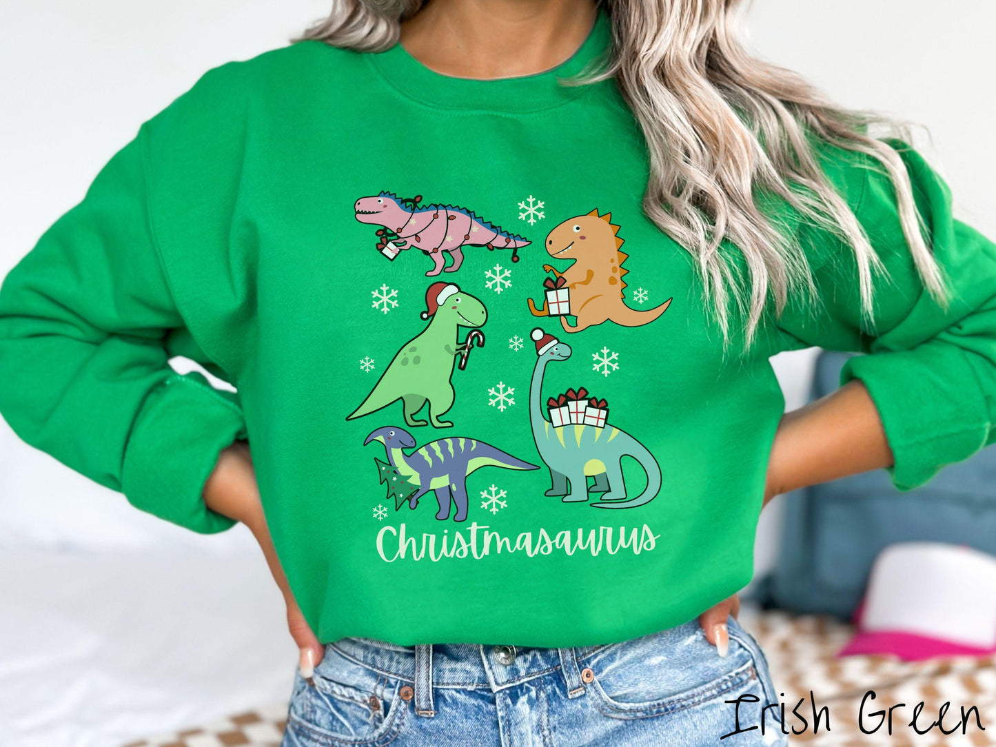 An adorable Irish green colored Christmasaurus Gildan sweatshirt. Featuring a variety of colorful dinosaurs dressed up for the holidays, this sweater exudes a playful and cheerful vibe.