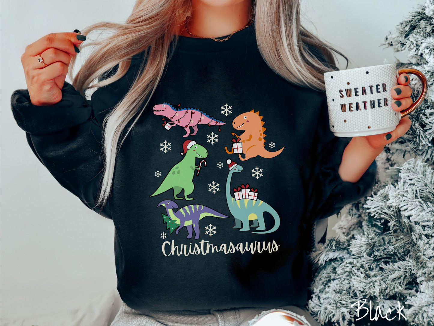 An adorable black colored Christmasaurus Gildan sweatshirt. Featuring a variety of colorful dinosaurs dressed up for the holidays, this sweater exudes a playful and cheerful vibe.