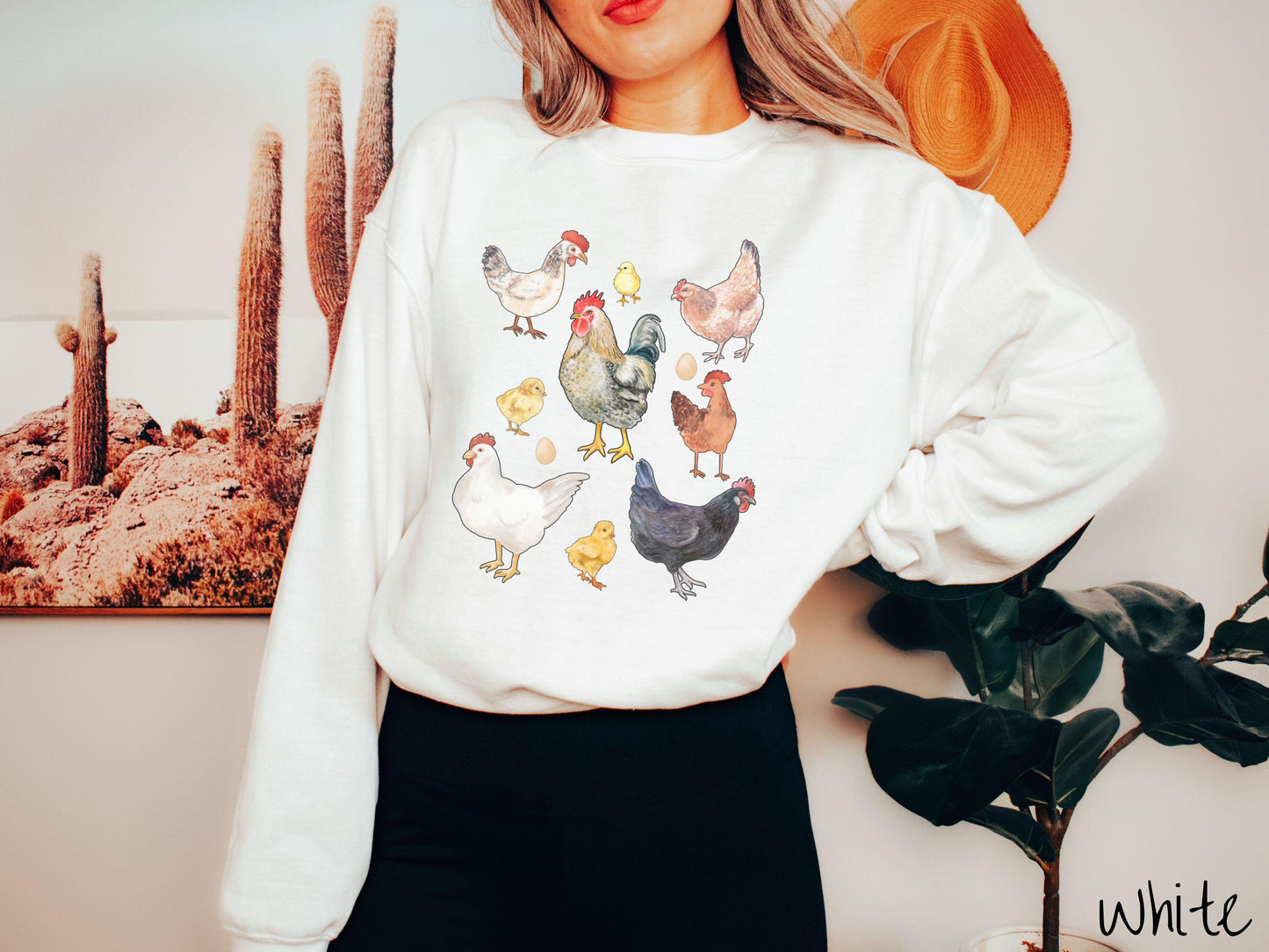 A vintage white colored Gildan sweatshirt featuring a grid style design of assorted colorful chickens, hens, and roosters in a grid design, with chicken eggs scattered among the design.