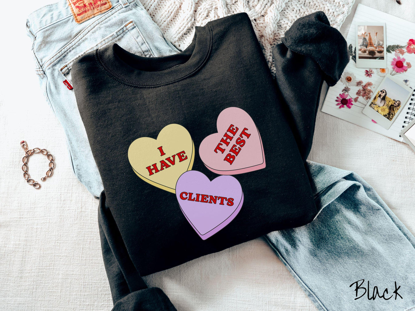 Show your appreciation for your amazing clients with this charming Gildan sweatshirt featuring three vibrant conversation hearts in yellow, red, and purple colors showcasing the text “I have the best clients” spread across the hearts.
