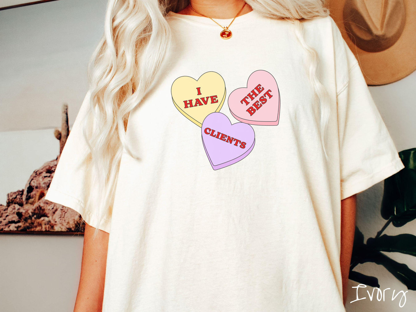 Show your appreciation for your amazing clients with this charming Comfort Colors t-shirt featuring three vibrant conversation hearts in yellow, red, and purple colors showcasing the text “I have the best clients” spread across the hearts.
