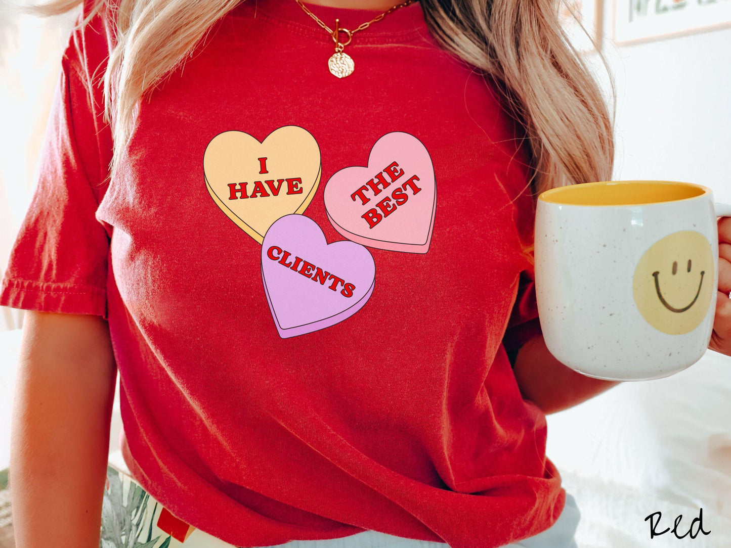 Show your appreciation for your amazing clients with this charming Comfort Colors t-shirt featuring three vibrant conversation hearts in yellow, red, and purple colors showcasing the text “I have the best clients” spread across the hearts.