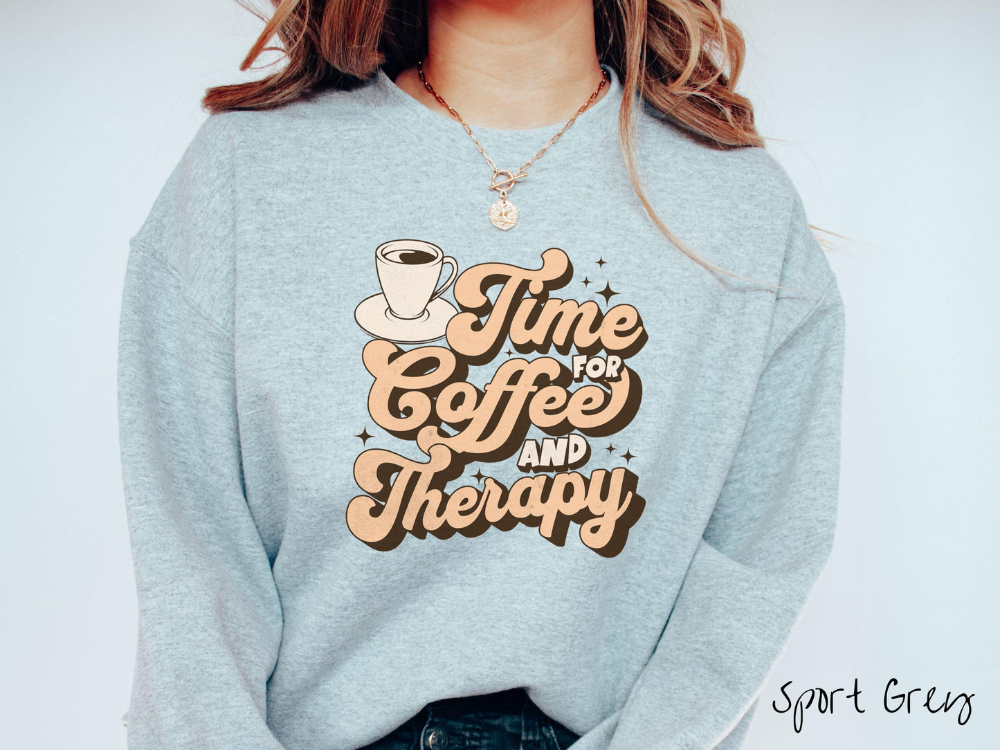 A vintage, sport grey colored Gildan sweatshirt featuring the text Time for Coffee and Therapy with a cup of coffee and stars in the background, giving off a cozy and comforting vibe.