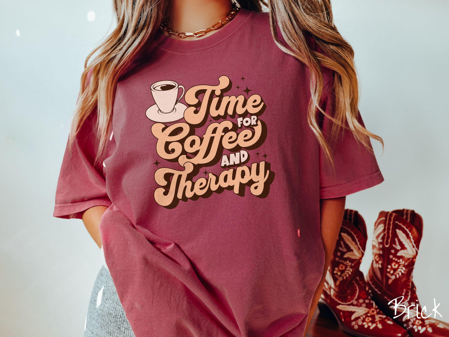 A vintage, brick colored Comfort Colors t-shirt featuring the text Time for Coffee and Therapy with a cup of coffee and stars in the background, giving off a cozy and comforting vibe.