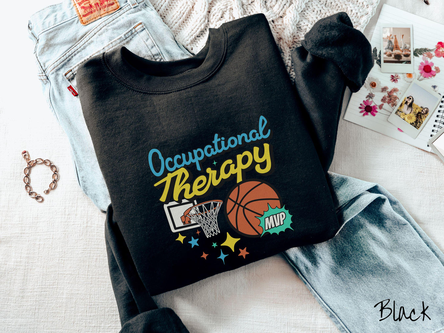 A vintage, black colored Gildan sweatshirt features the phrase "Occupational Therapy" above a basketball goal, complemented by a bold basketball graphic with the text "MVP".