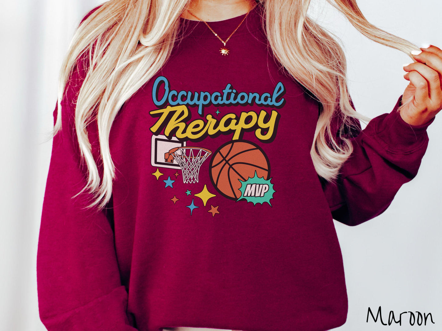 A vintage, maroon colored Gildan sweatshirt features the phrase "Occupational Therapy" above a basketball goal, complemented by a bold basketball graphic with the text "MVP".