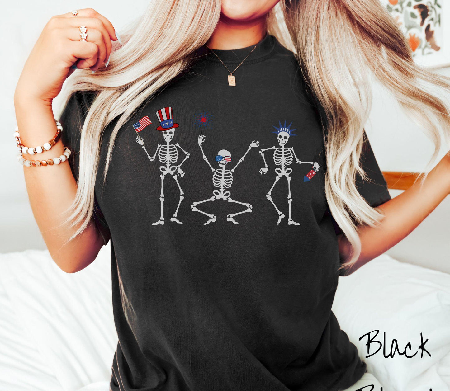 Celebrate in style with this vintage-inspired tee featuring three dancing skeletons decked out in red, white, and blue hats. They hold American flags, sparklers, and fireworks, making it the perfect shirt for Fourth of July celebrations.