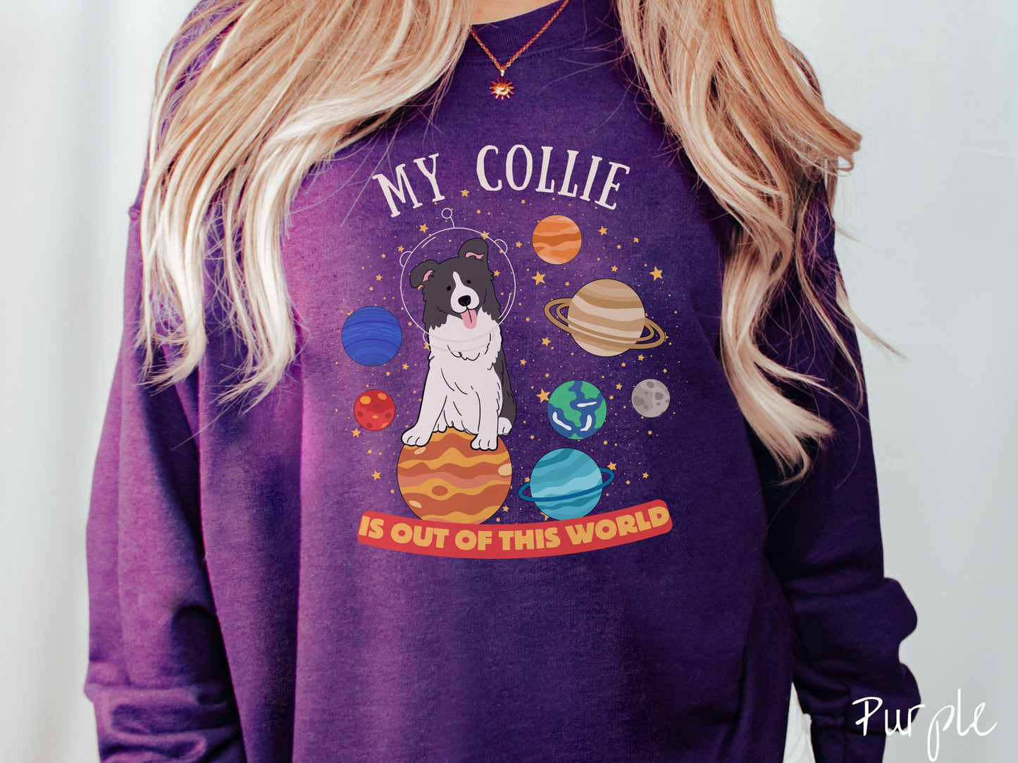 A vintage Gildan sweatshirt featuring the text My Collie is Out of This World. The design showcases an adorable Border Collie sitting proudly atop Jupiter, surrounded by a vibrant solar system filled with colorful planets and twinkling stars.