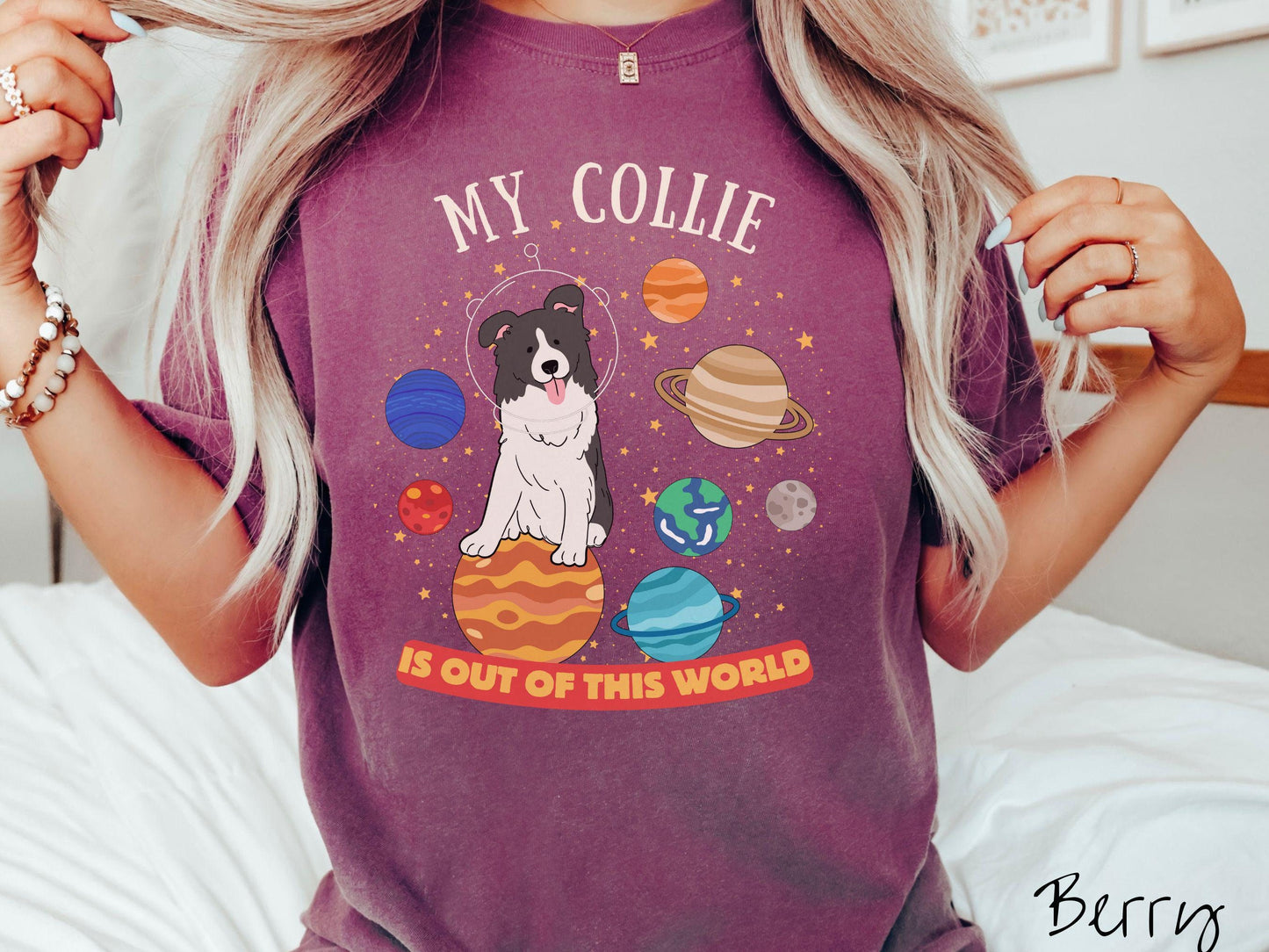 A vintage Comfort Colors t-shirt featuring the text My Collie is Out of This World. The design showcases an adorable Border Collie sitting proudly atop Jupiter, surrounded by a vibrant solar system filled with colorful planets and twinkling stars.