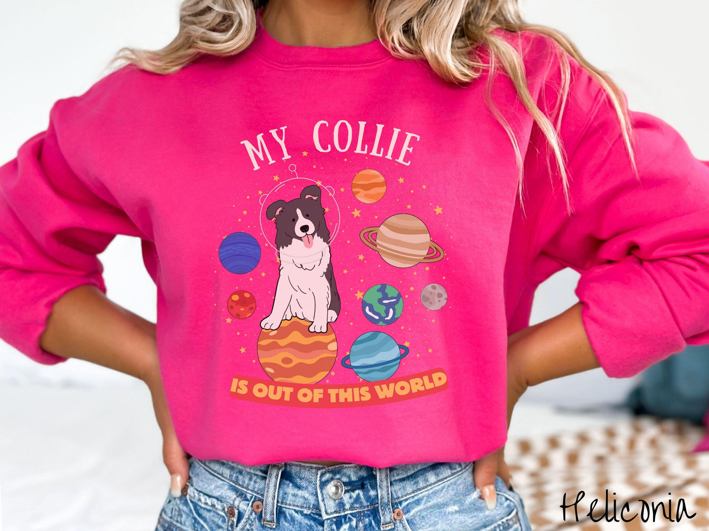 A vintage Gildan sweatshirt featuring the text My Collie is Out of This World. The design showcases an adorable Border Collie sitting proudly atop Jupiter, surrounded by a vibrant solar system filled with colorful planets and twinkling stars.