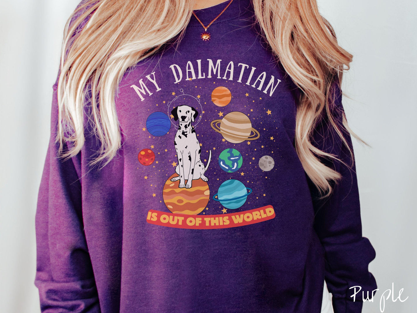 A vintage Gildan sweatshirt featuring the text My Dalmation is Out of This World. The design showcases a Dalmation sitting proudly atop Jupiter, surrounded by a vibrant solar system filled with colorful planets and twinkling stars.