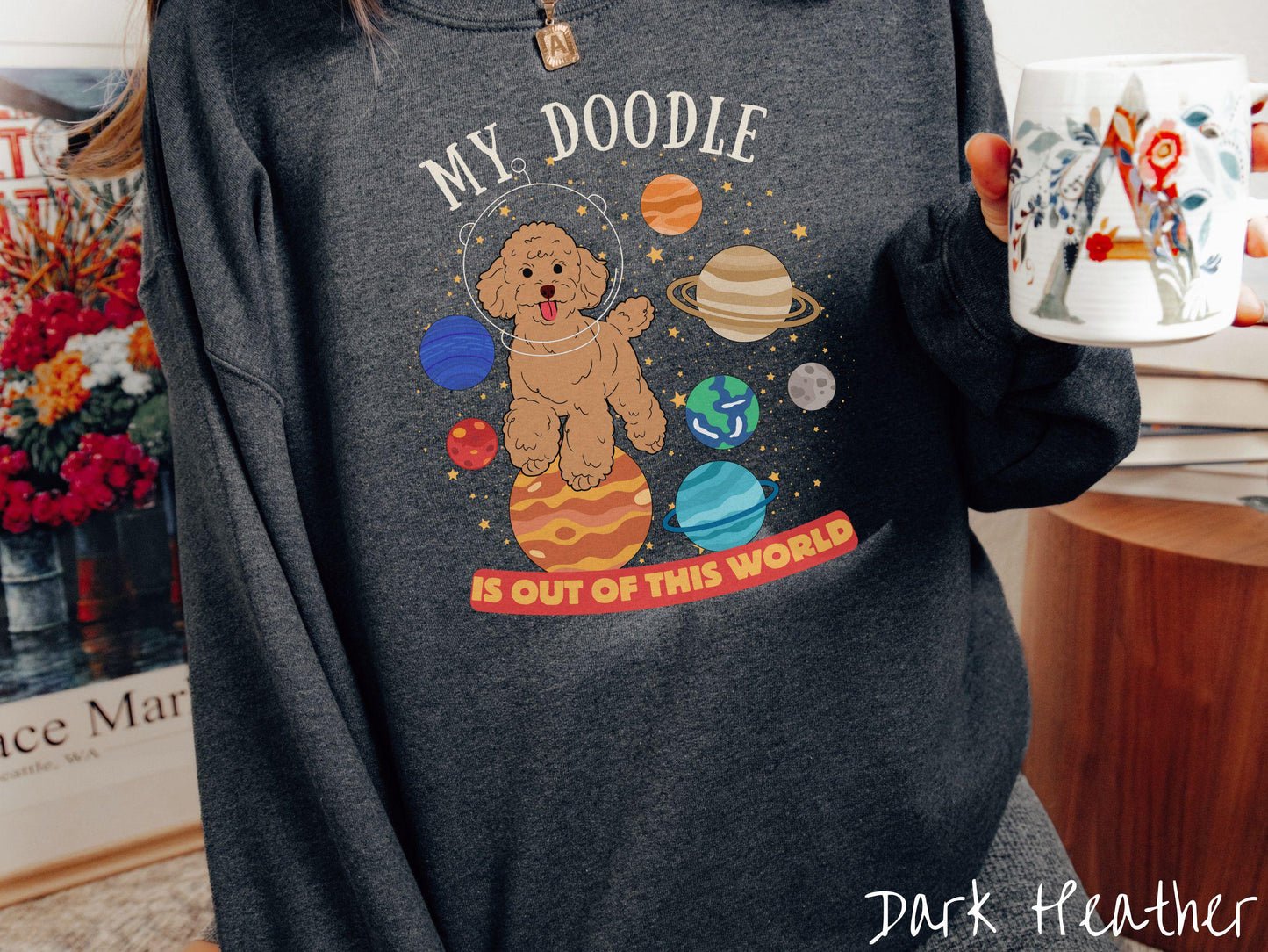 A vintage Gildan sweatshirt featuring the text My Doodle is Out of This World. The design showcases a German Shepherd sitting proudly atop Jupiter, surrounded by a vibrant solar system filled with colorful planets and twinkling stars.