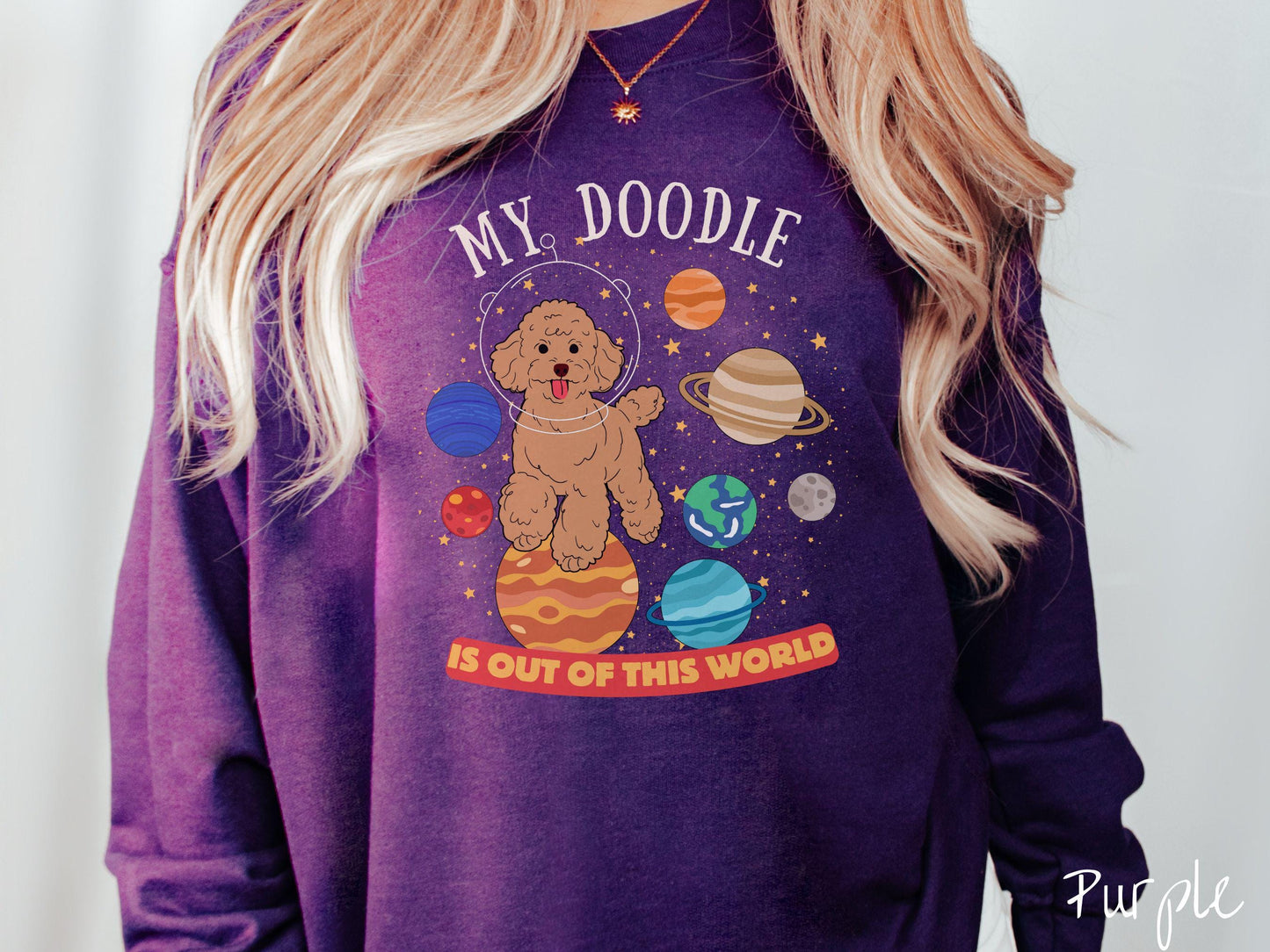 A vintage Gildan sweatshirt featuring the text My Doodle is Out of This World. The design showcases a German Shepherd sitting proudly atop Jupiter, surrounded by a vibrant solar system filled with colorful planets and twinkling stars.