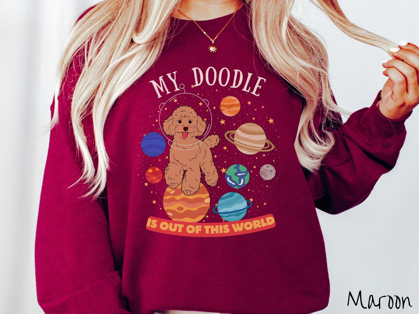 A vintage Gildan sweatshirt featuring the text My Doodle is Out of This World. The design showcases a German Shepherd sitting proudly atop Jupiter, surrounded by a vibrant solar system filled with colorful planets and twinkling stars.