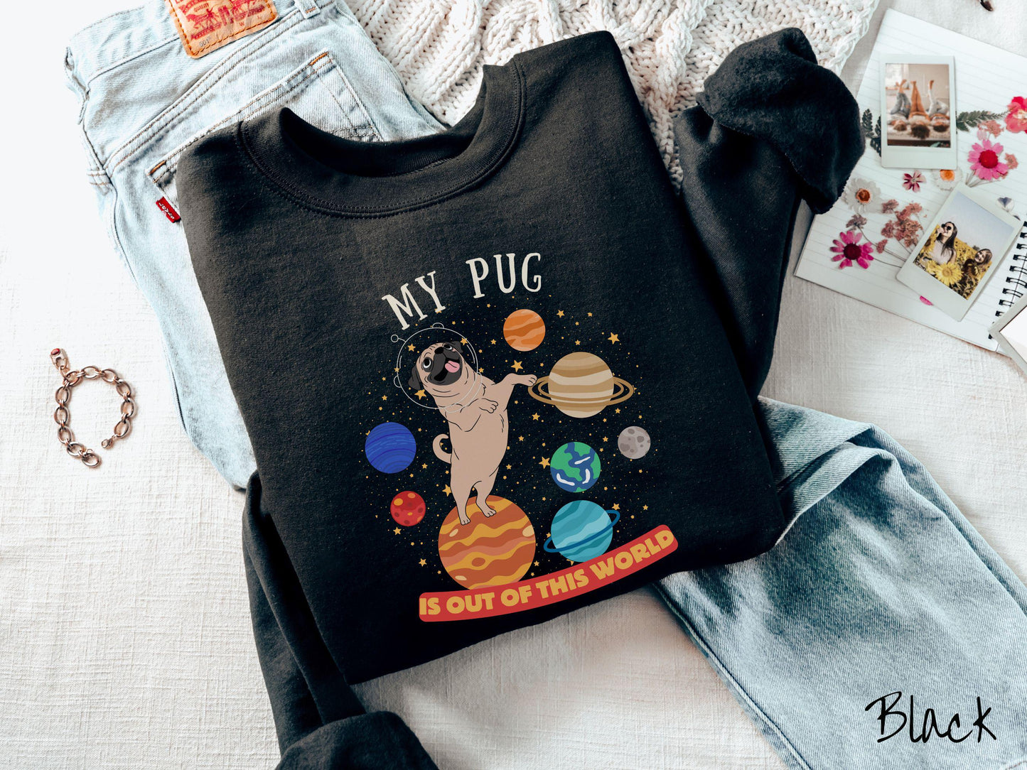 A vintage Gildan sweatshirt featuring the text My Pug is Out of This World. The design showcases an adorable Pug sitting proudly atop Jupiter, surrounded by a vibrant solar system filled with colorful planets and twinkling stars.