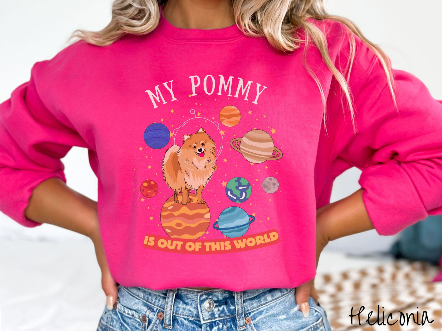 A vintage Gildan sweatshirt featuring the text My Pomeranian is Out of This World. The design showcases a German Shepherd sitting proudly atop Jupiter, surrounded by a vibrant solar system filled with colorful planets and twinkling stars.