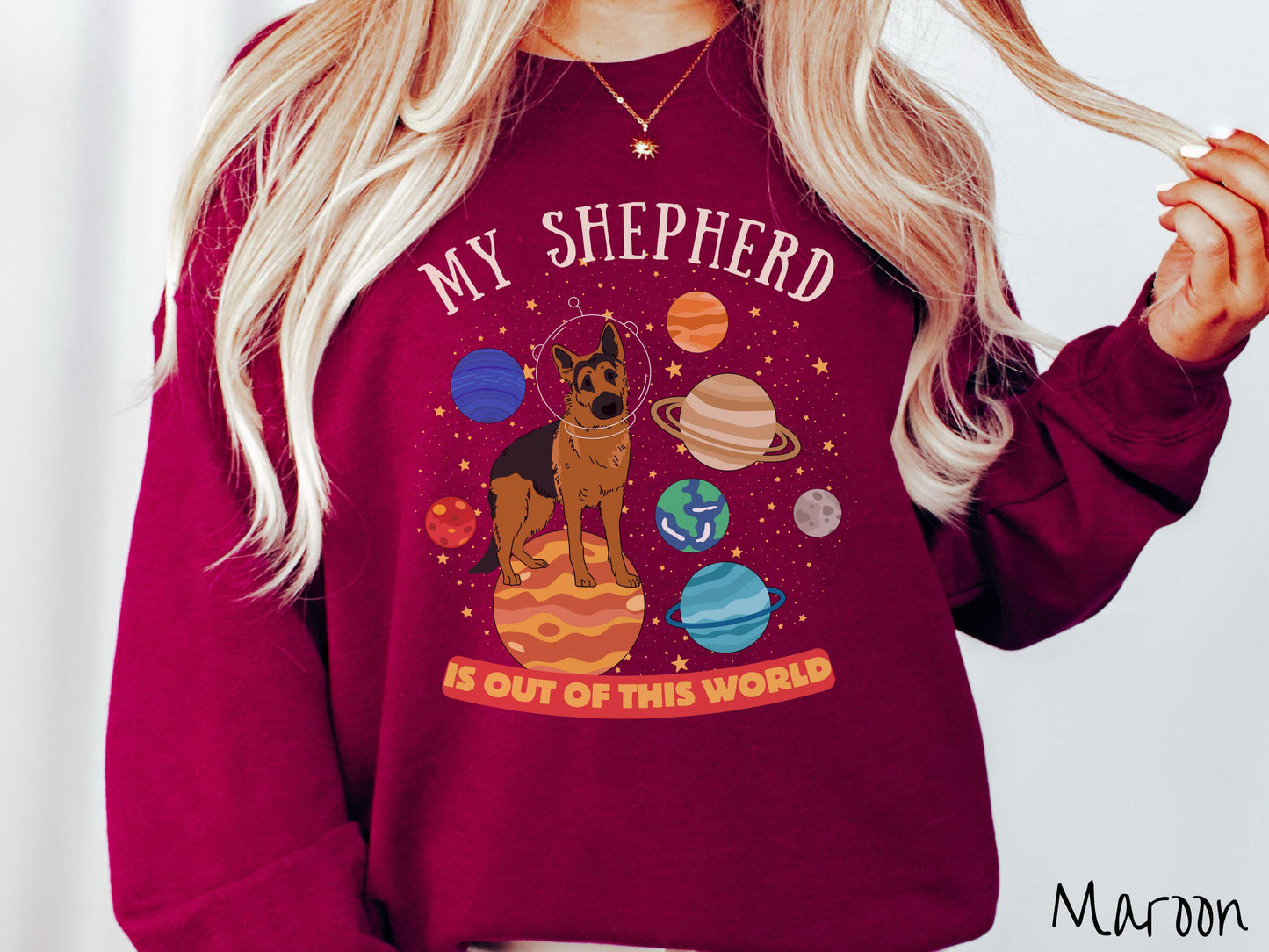 A vintage Gildan sweatshirt featuring the text My Shepherd is Out of This World. The design showcases a German Shepherd sitting proudly atop Jupiter, surrounded by a vibrant solar system filled with colorful planets and twinkling stars.