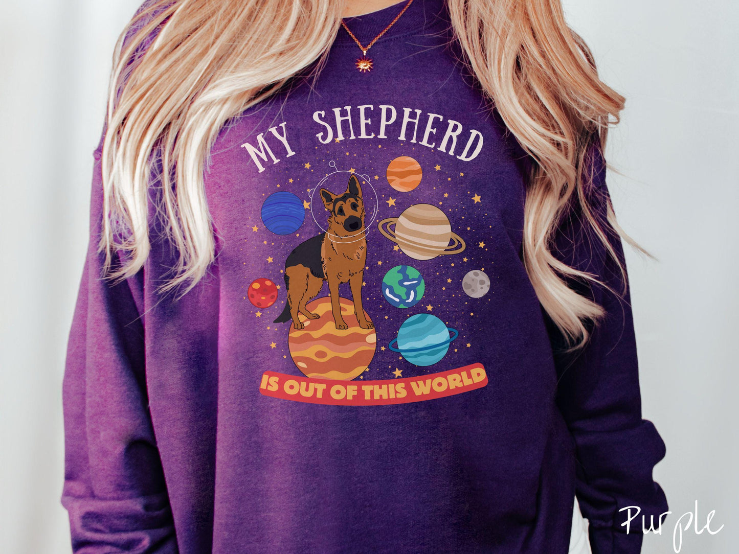 A vintage Gildan sweatshirt featuring the text My Shepherd is Out of This World. The design showcases a German Shepherd sitting proudly atop Jupiter, surrounded by a vibrant solar system filled with colorful planets and twinkling stars.