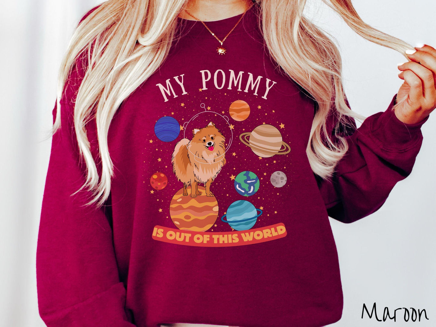 A vintage Gildan sweatshirt featuring the text My Pomeranian is Out of This World. The design showcases a German Shepherd sitting proudly atop Jupiter, surrounded by a vibrant solar system filled with colorful planets and twinkling stars.