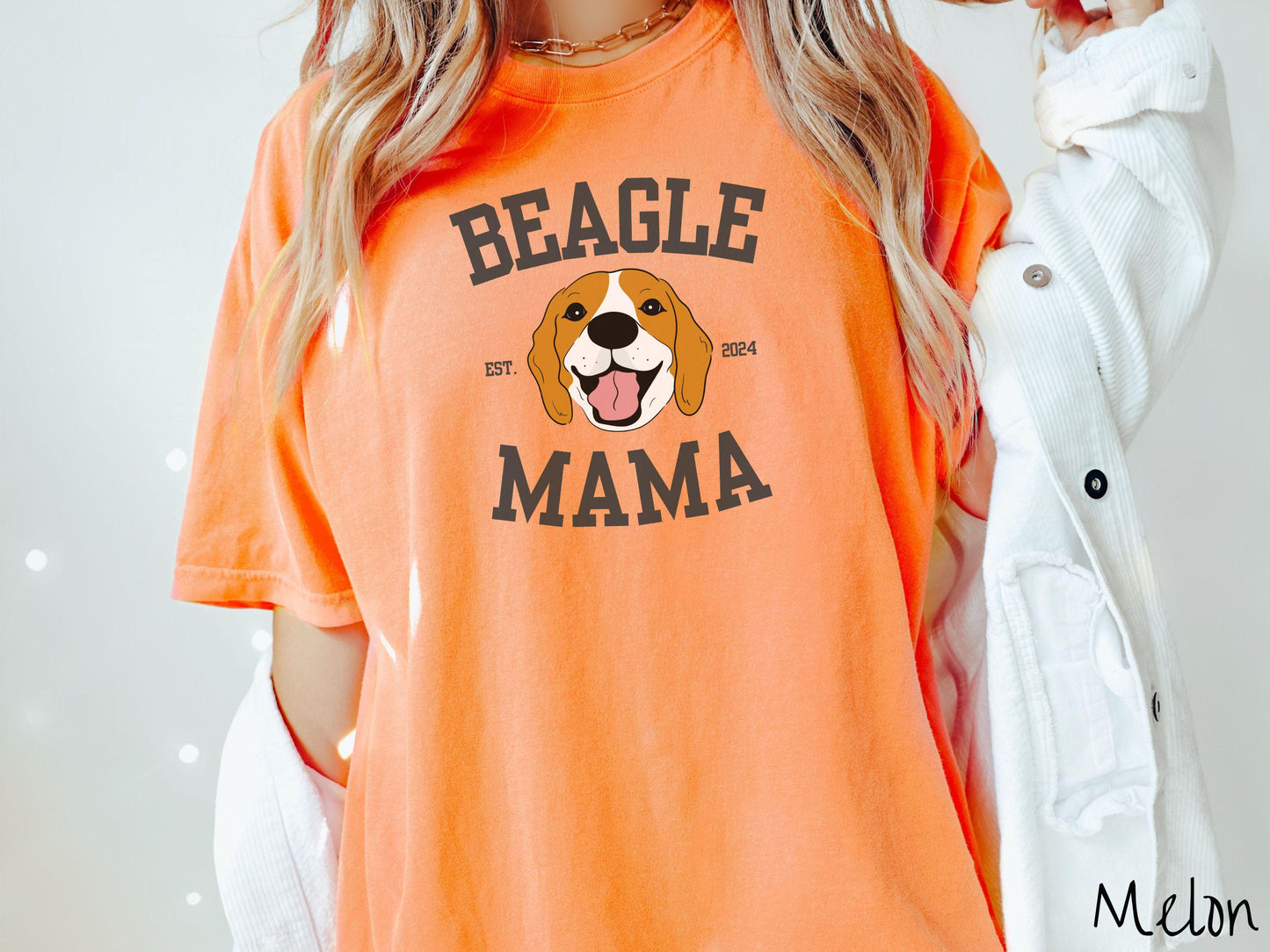 A vintage Comfort Colors t-shirt for every proud Beagle Mama! The design features the words Beagle Mama in a university-style font, framing an orange, black, and brown beagle. The playful touch of "EST. 2024" adds a personal charm to the design.