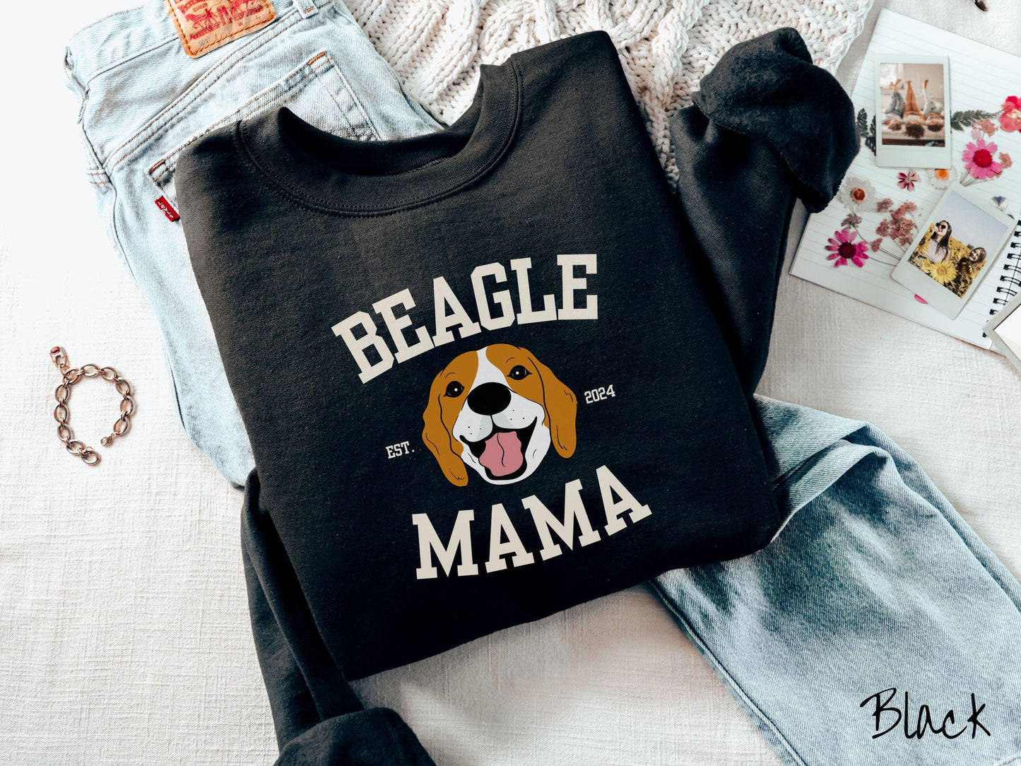 A vintage Gildan sweatshirt for every proud Beagle Mama! The design features the words Beagle Mama in a university-style font, framing an orange, black, and brown beagle. The playful touch of "EST. 2024" adds a personal charm to the design.