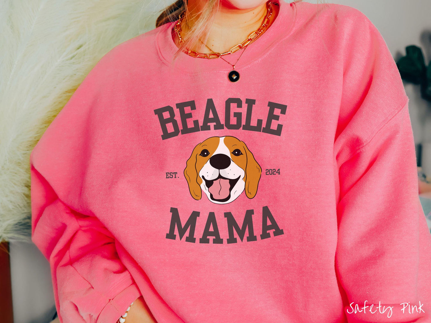 A vintage Gildan sweatshirt for every proud Beagle Mama! The design features the words Beagle Mama in a university-style font, framing an orange, black, and brown beagle. The playful touch of "EST. 2024" adds a personal charm to the design.